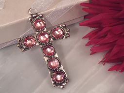 Shimmering silver cross with pink crystals